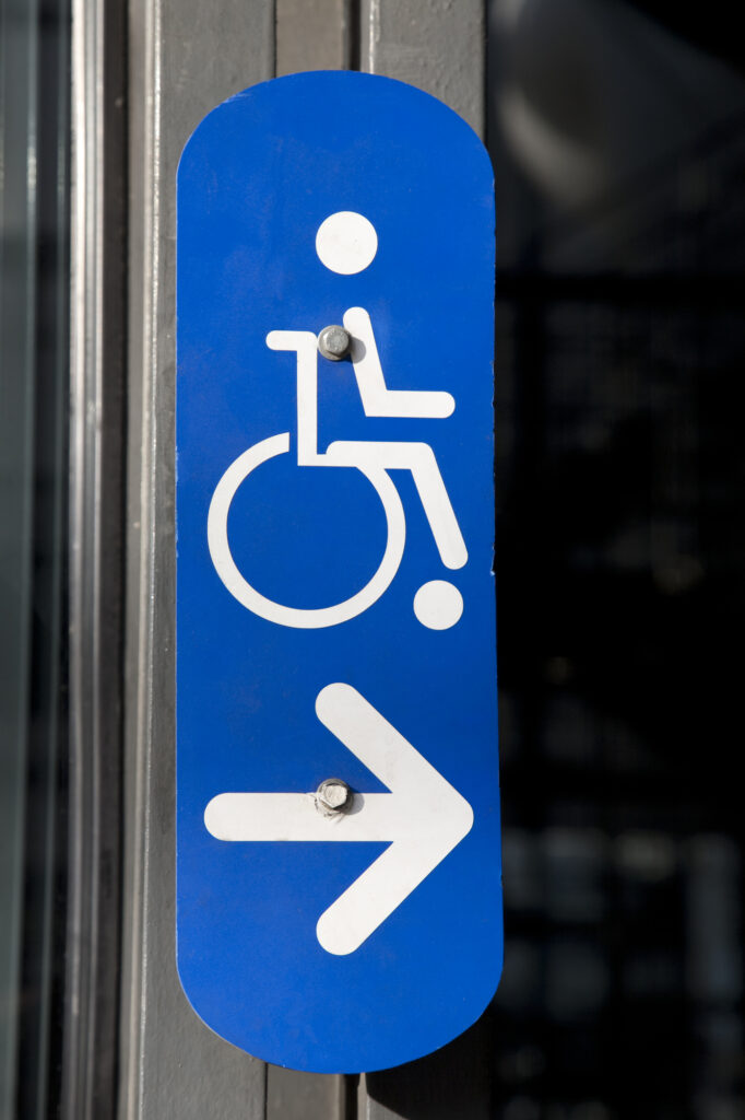 Blue Disabled Sign on Building Entrance